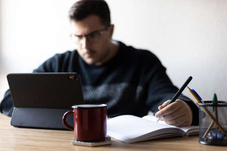 A busy man is focus on working at homeの写真素材