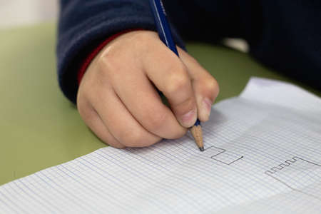 Student is drawing different forms in his note book. He is learning Arts.の写真素材