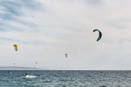 Man is practicing kitesurf in the sea. He is ridging waves.の写真素材