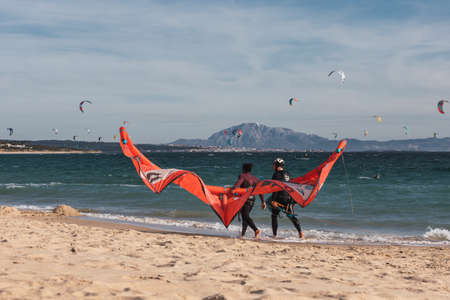 Man is practicing kitesurf. He is talking with his instructor.の写真素材