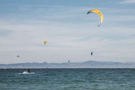 Man is practicing kitesurf in the sea. He is ridging waves.の写真素材