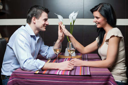 Attractive couple drinking wine and flirtingの写真素材