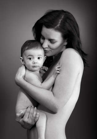 Loving mother holding baby - BW studio shotの写真素材