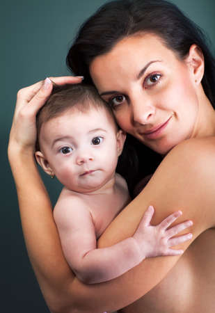 Loving mother holding baby - studio shotの写真素材