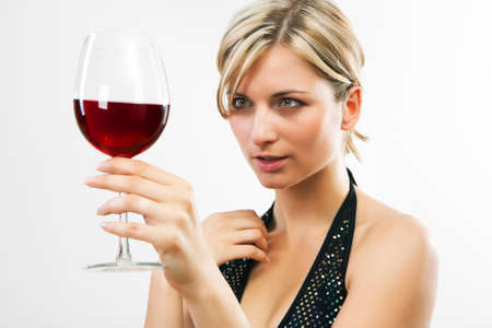 Young woman holding red wine - white backgroundの写真素材
