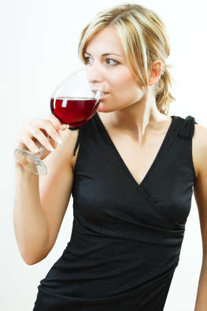 Young beautiful woman with glass of wineの写真素材