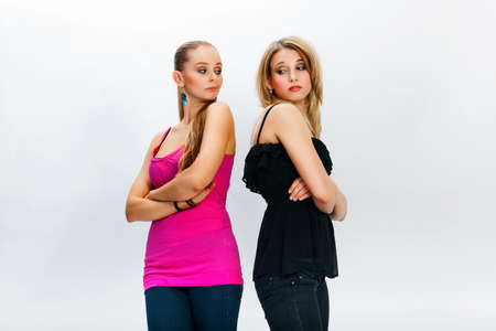 Two young women in conflict - portrait on white bacground