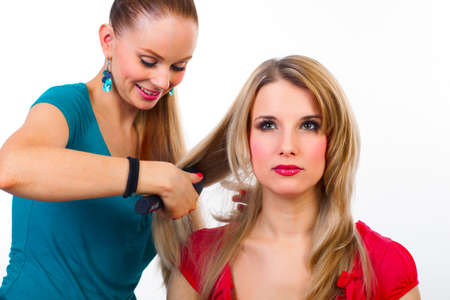 Beautiful young woman gets a hairdo in the beauty-shopの写真素材