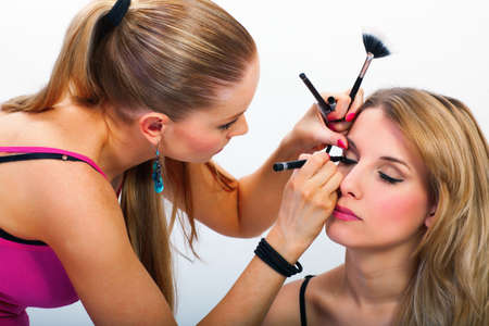 Make-up artist applying mascara on model's eyelashesの写真素材