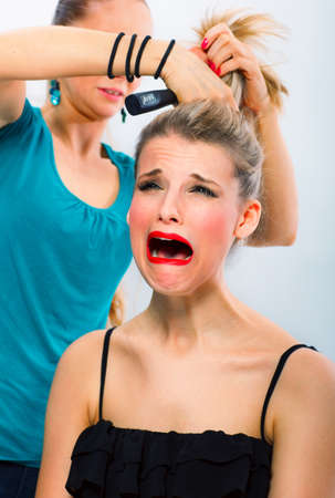 Frightened woman unsatisfied with her hairdresser の写真素材