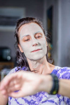 A girl applying a beauty treatment, taking advantage of the confinementの写真素材
