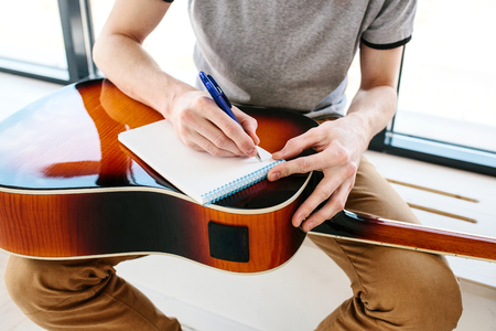 Learning to play the guitar. Music education.の写真素材
