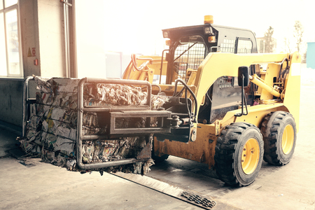 Forklift truck. Waste processing plant. Technological process. Recycling and storage of waste for further disposal. Business for sorting and processing of waste.の写真素材
