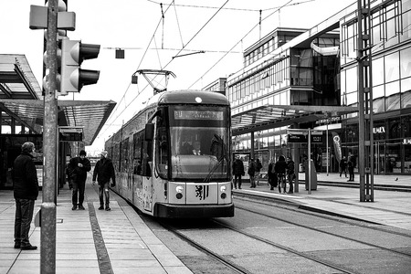 Dresden, Germany, December 19, 2016: The modern tramway in Dresden in Germany. Disembarkation of passengers at the railway station. A photo in black and white style.のeditorial素材