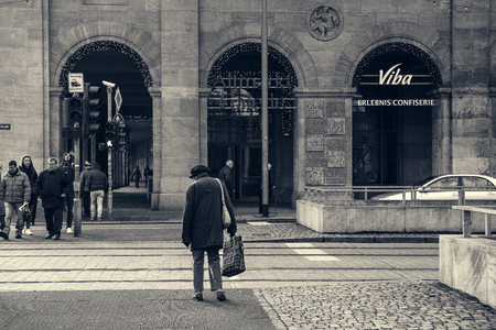 Dresden, Germany, December 19, 2016: The old German woman crosses the road. Life in Europe. Lifestyleのeditorial素材