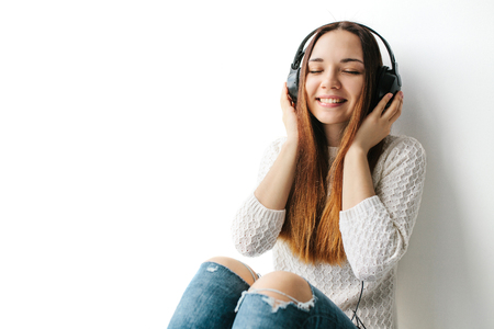 Beautiful girl is listening to the musicの写真素材