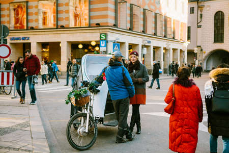 Munich, Germany, December 29, 2016: A man on a date with a woman in the center of Munich in the Marienplatz square. Tender feelings, love, relationship between a man and a woman.のeditorial素材