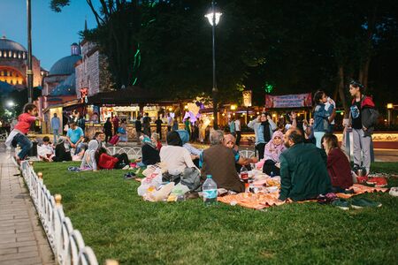 Istanbul, June 16, 2017: Many people of the Islamic religion take food on the Sultanahmet square next to the blue mosque along with their relatives at the time allowed in the Ramadan fast. Ramazan.のeditorial素材