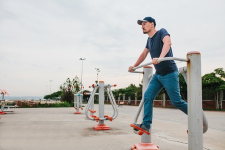 A man trains on sporting equipment in a city in the open air. The concept of a healthy lifestyle and...