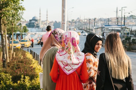 Istanbul, June 15, 2017: Islamic women in traditional attire communicate with each other and wait for a taxi on the street in Istanbul. Turkey.のeditorial素材