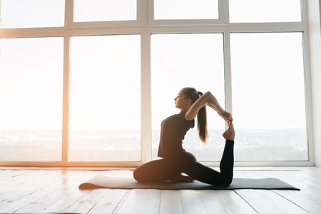 Young beautiful woman practicing yoga and gymnastic. Wellness concept. Classes in single sports.の写真素材