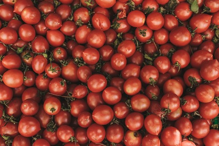 Red fresh tomatoes background. Natural local products on the farm market. Harvesting. Seasonal products. Food. Vegetables.の写真素材