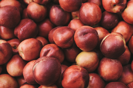 Peaches background. Natural local products on the farm market. Harvesting. Seasonal products. Food. Vegetables.の写真素材