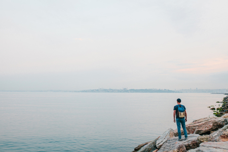 A tourist with a backpack on the coast. Travel, tourism.の写真素材