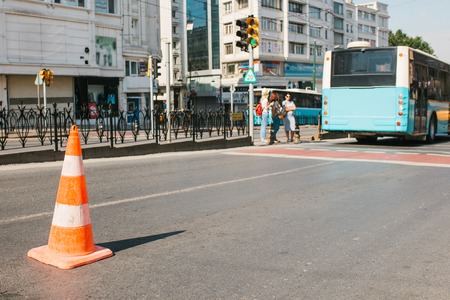 Selective focus on the road cone on the road. Road sign. Road works on the streets of Istanbul in Turkey. Blurry background.の写真素材