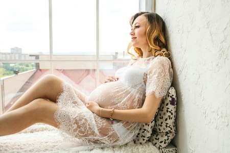 Beautiful adult pregnant woman. Waiting for the baby. Pregnancy. Care, tenderness, motherhood, childbirth.の写真素材
