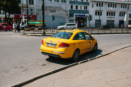 Istanbul, June 11, 2017: A traditional yellow taxi on the street in Istanbul, Turkey. Urban life style. Transportation of passengers. Waiting for customers.のeditorial素材