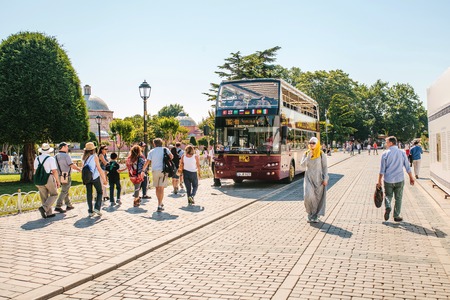Istanbul, June 15, 2017: Tourist sightseeing bus picking up passengers at the stop at Sultanahmet squareのeditorial素材