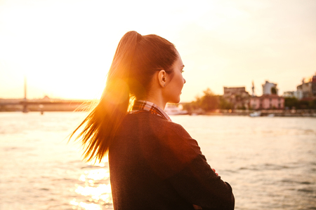 Young beautiful girl at sunset next to the Bosphorus on the background of Istanbul. Turkey. Rest, vacation.の写真素材