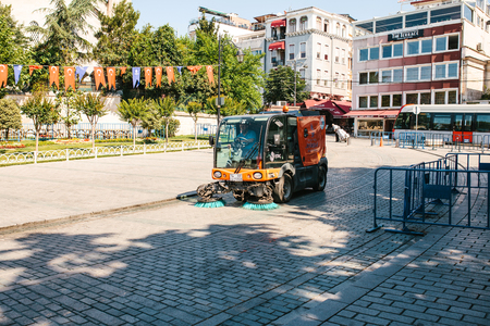 Istanbul, June 16, 2017: Street janitor using cleaning machine to sweep and clean sidewalk tileのeditorial素材