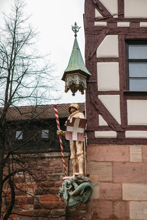 Sculpture of a knight in armor on the facade of a house in Nuremberg, Germany.の写真素材