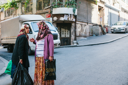 Istanbul, June 11, 2017: Two elderly women chatting on the street. Lifestyle, authentic. Daytime scene.のeditorial素材