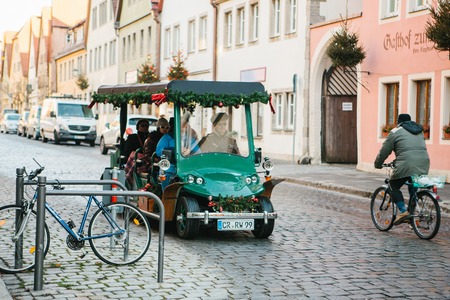 Rothenburg ob der Tauber, Germany, December 30, 2016: Trip on the decorated car. Entertainment of tourists during the Christmas holidays. Christmas in Europe.のeditorial素材
