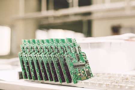 Computer boards stand in a row at the factory for the production of spare parts.の写真素材