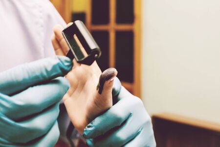 The investigator takes fingerprints from the suspect in the crime. Investigation is a crime. Crime.の写真素材