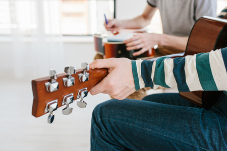 Learning to play the guitar. Music education and extracurricular lessons.の写真素材