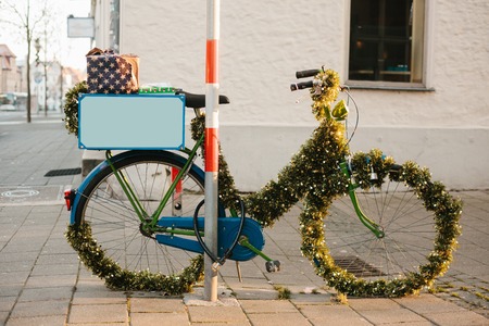 A bike decorated in a Christmas style on the street of a European city. Celebrating Christmas in Europe.の写真素材