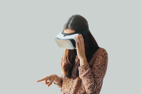 Young woman with virtual reality glasses. The concept of future technology.の写真素材