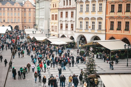 Prague, December 13, 2016: Old Town Square in Prague on Christmas Day. Christmas market in the main square of the city. Happy local residents and tourists walk and rest. Holidays.のeditorial素材