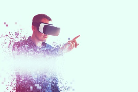 A person in virtual glasses flies to pixels. The man with glasses of virtual reality. Future technology concept. Modern imaging technology. Fragmented by pixels.の写真素材