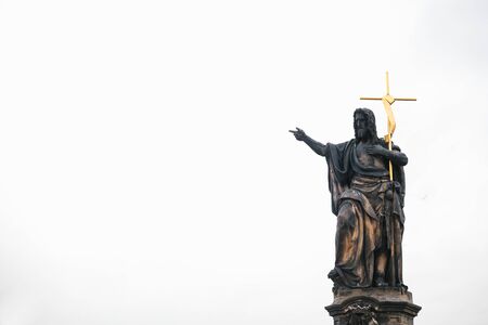 Sculpture of St. John the Baptist. One of the ancient statues on the Charles Bridge in Prague in the Czech Republic. European old architecture.の写真素材
