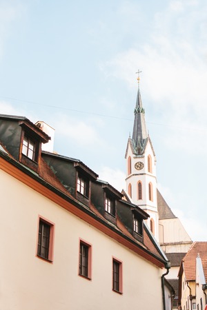 An interesting view of the St. Vitus Church and the house in Cesky Krumlov in the Czech Republic. The church is one of the main sights of the town.の写真素材