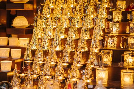 Beautiful burning Christmas lights in the store. Close-up - showcase in store with beautiful souvenirs - burning Christmas lights in the form of Xmas trees and glasses.の写真素材