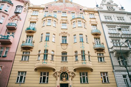 Prague, December 20, 2016: Architecture of Prague. Luxurious old houses of different colors stand closely next to each other with decor elements and balconiesのeditorial素材