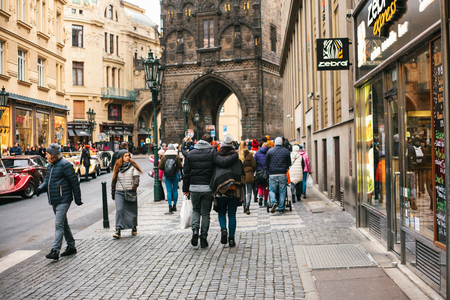 Prague, December 24, 2016: Tourism in Prague. Crowd of people walk through the beautiful Charles Bridge through shops, attractions and cafesのeditorial素材