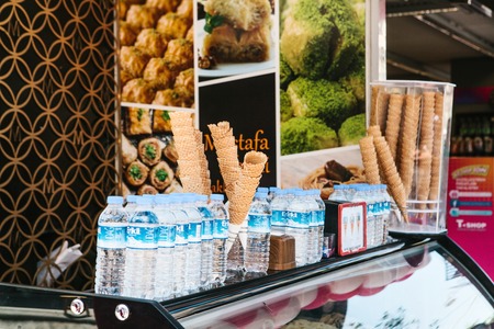 Istanbul, June 16, 2017: Street stall selling snacks in waffle horn and water in plastic bottles on...